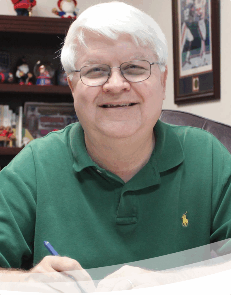 Photo of Robert McRaney sitting at his desk.