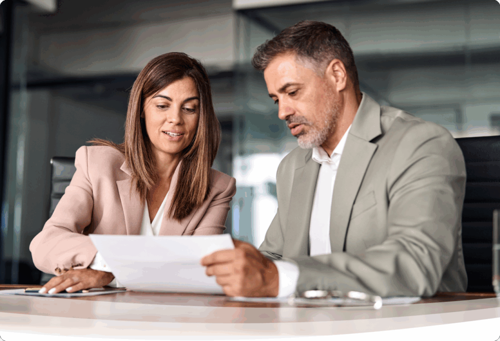 a man and woman looking at a piece of paper